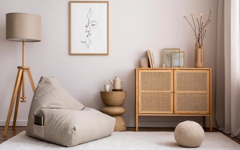 a living room with a white couch and a white wall with art