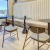 a room with a table chairs and a window